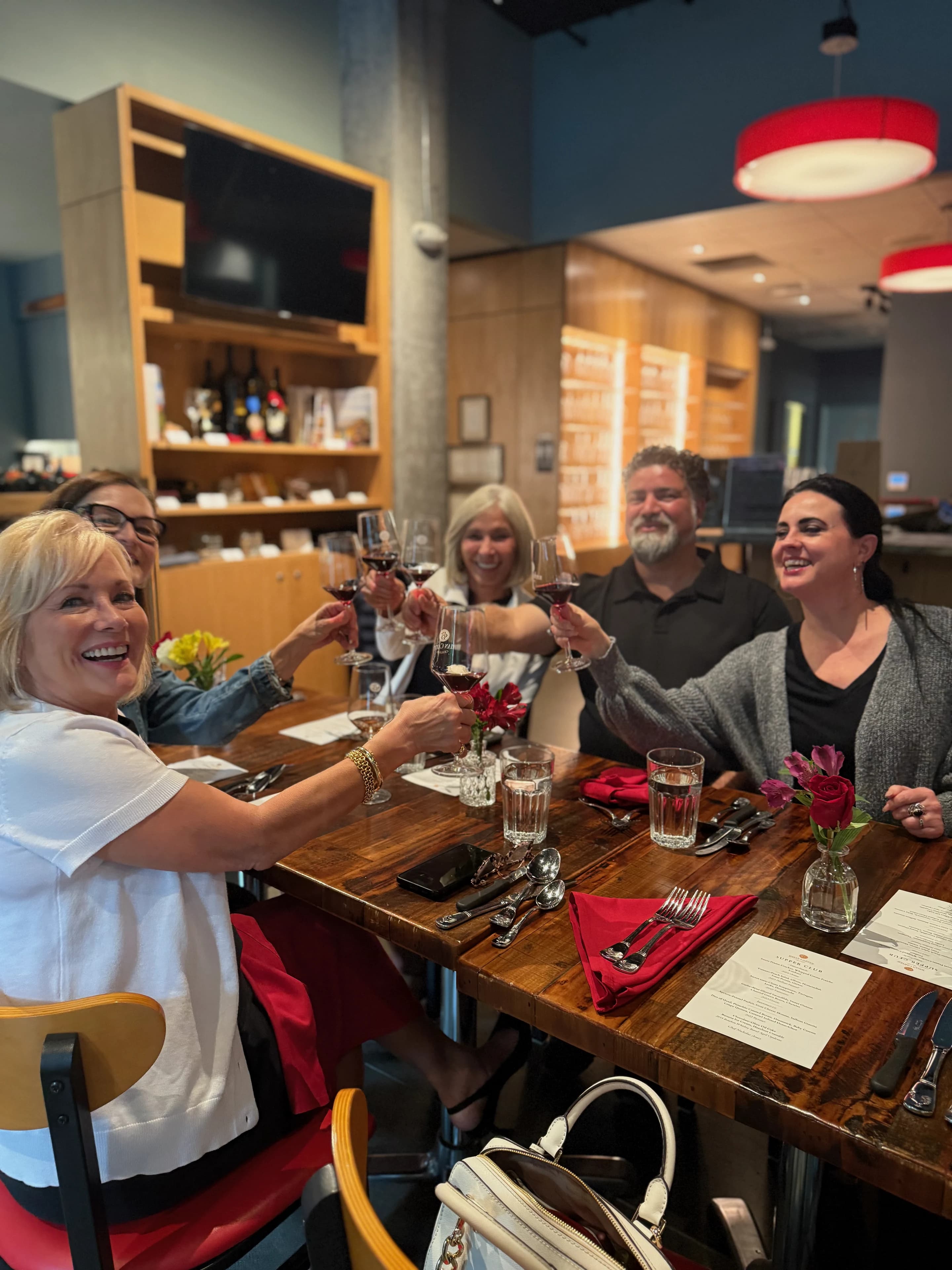 Guests toasting at a table in the Woodinville Tasting Room and Bistro